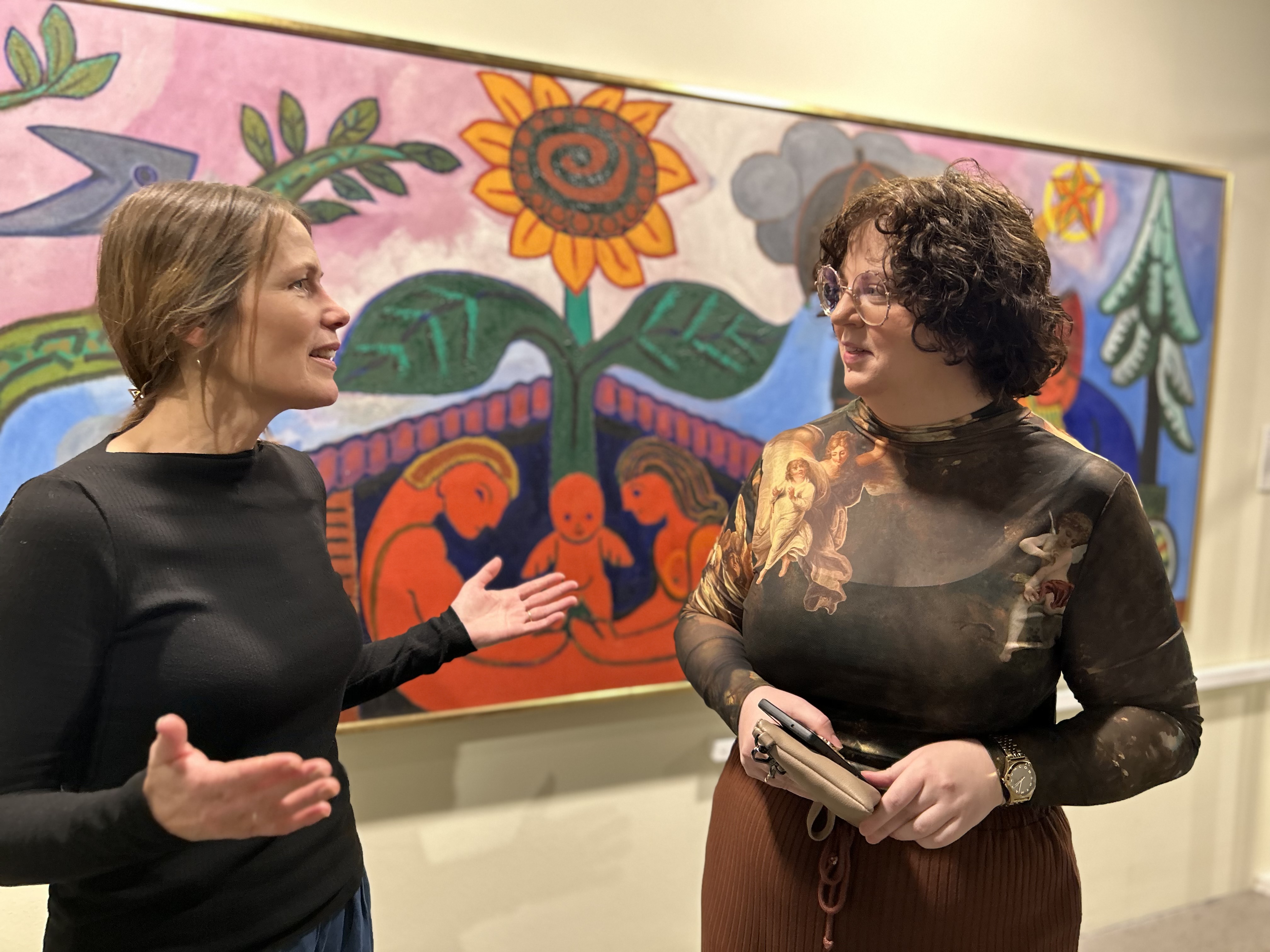 To kvinder taler foran maleri